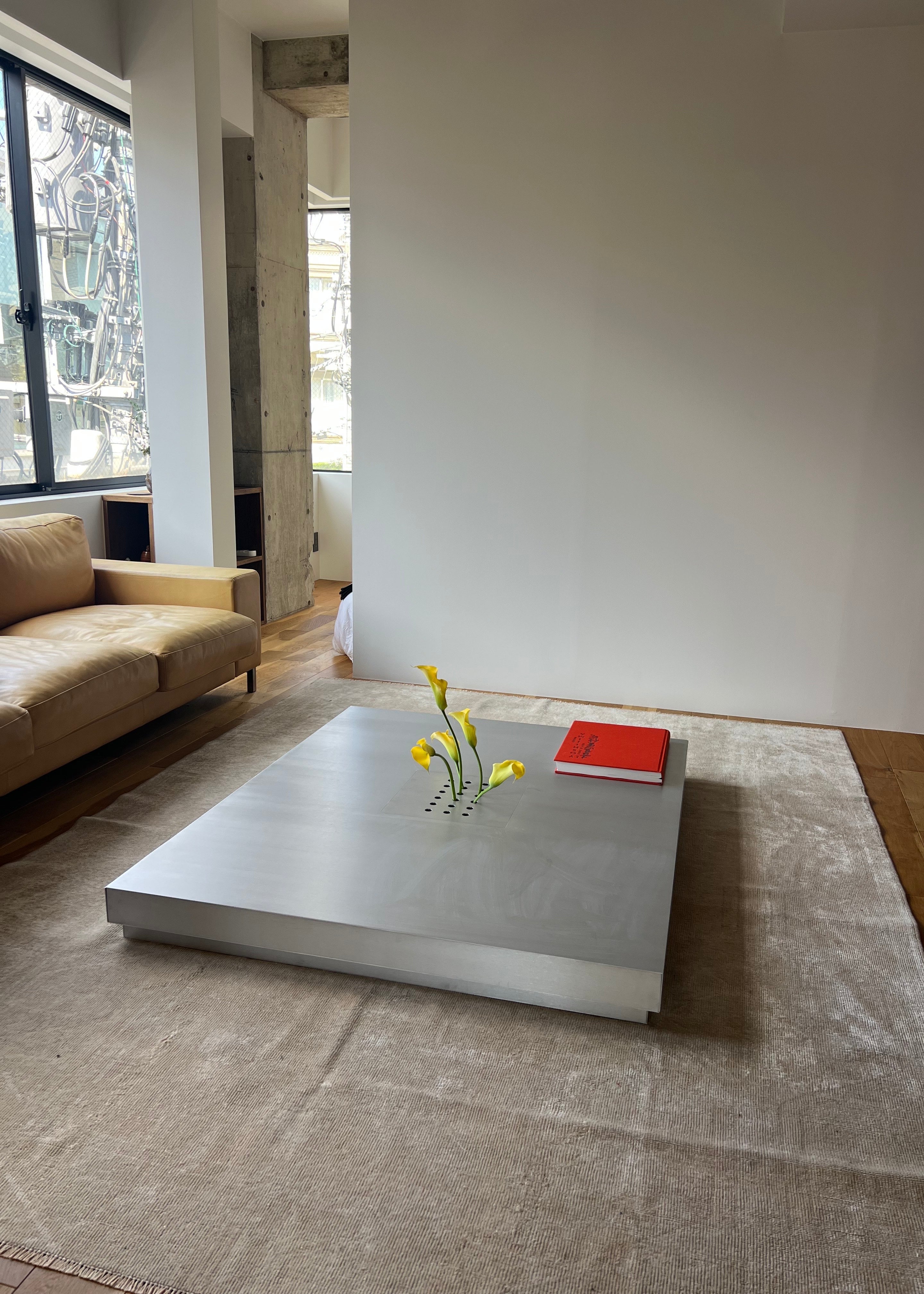 Low metal table. Hole with cover