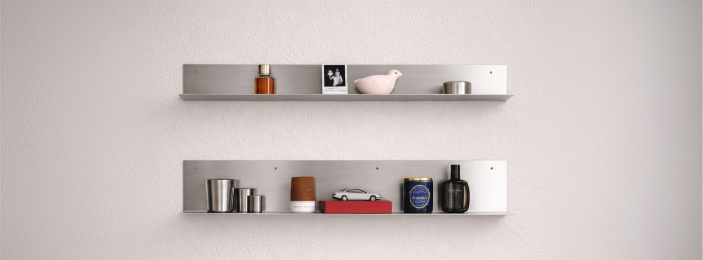 Modern stainless steel wall shelf by Alumproject featuring a sleek, industrial design for minimalist interiors.