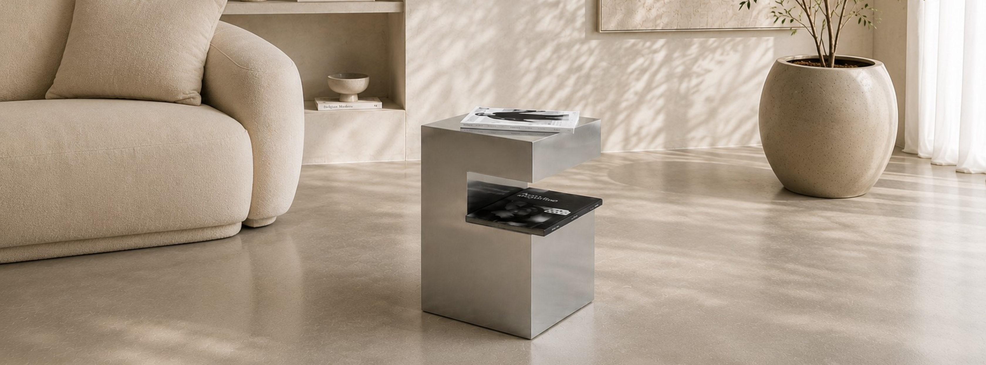 Small C-shaped aluminum side table by Alumproject in a modern minimalist interior.