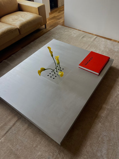 Low metal table. Hole with cover