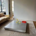 Low metal table. Hole with cover
