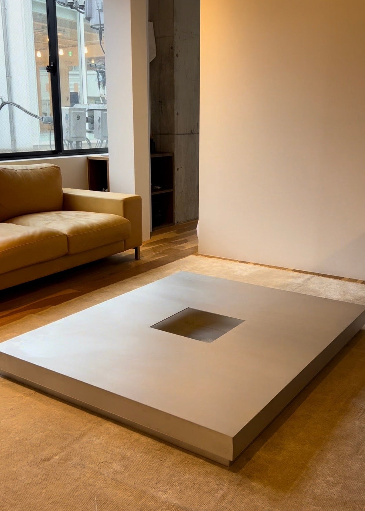 Low metal table. Hole with cover