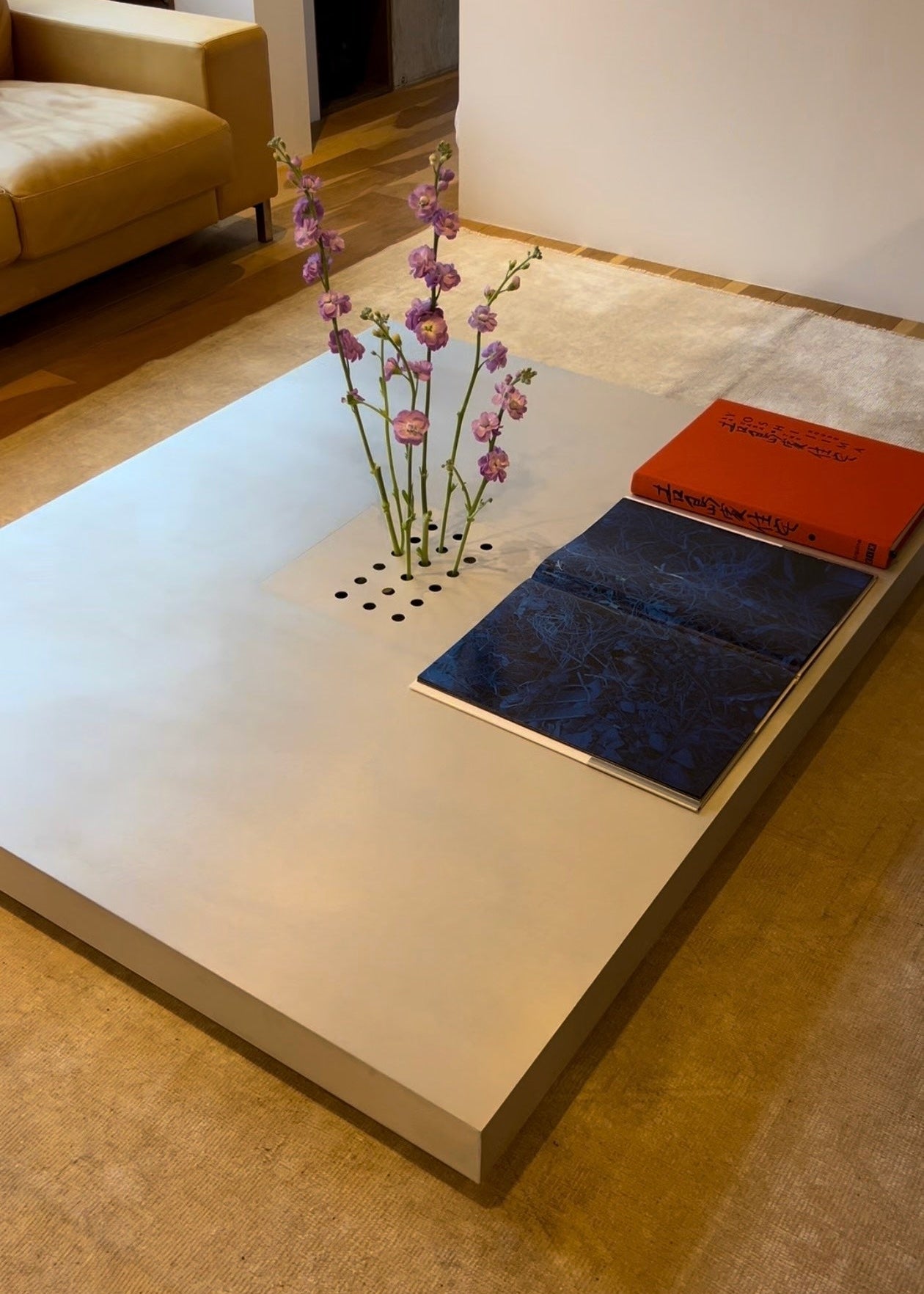 Low metal table. Hole with cover